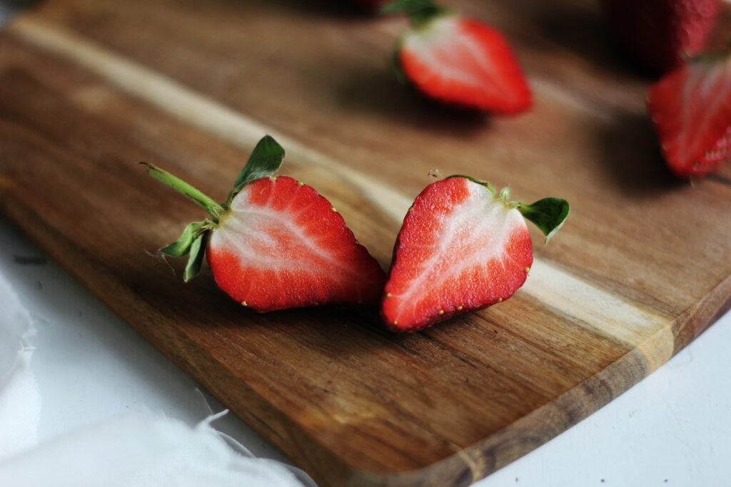 Cut the Strawberries | Halved strawberries on a chopping board