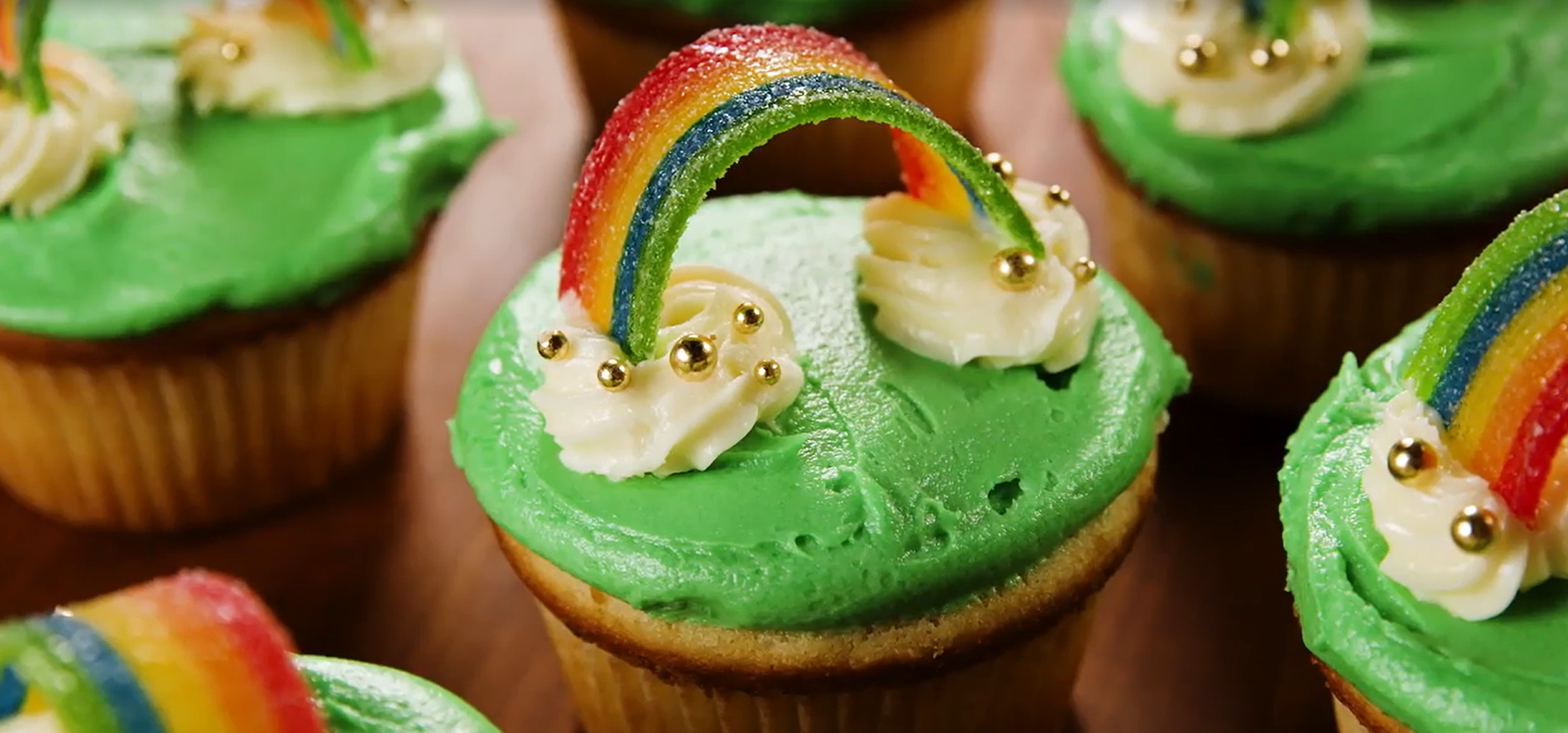 Green and Rainbow-Topped Vanilla Cupcakes by Delish